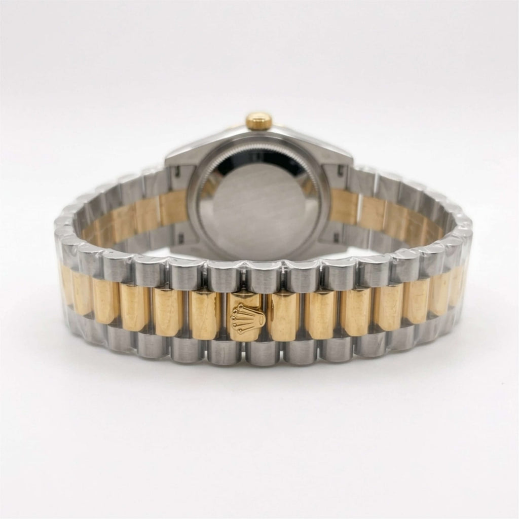 Two-tone watch with silver and gold band on a white background