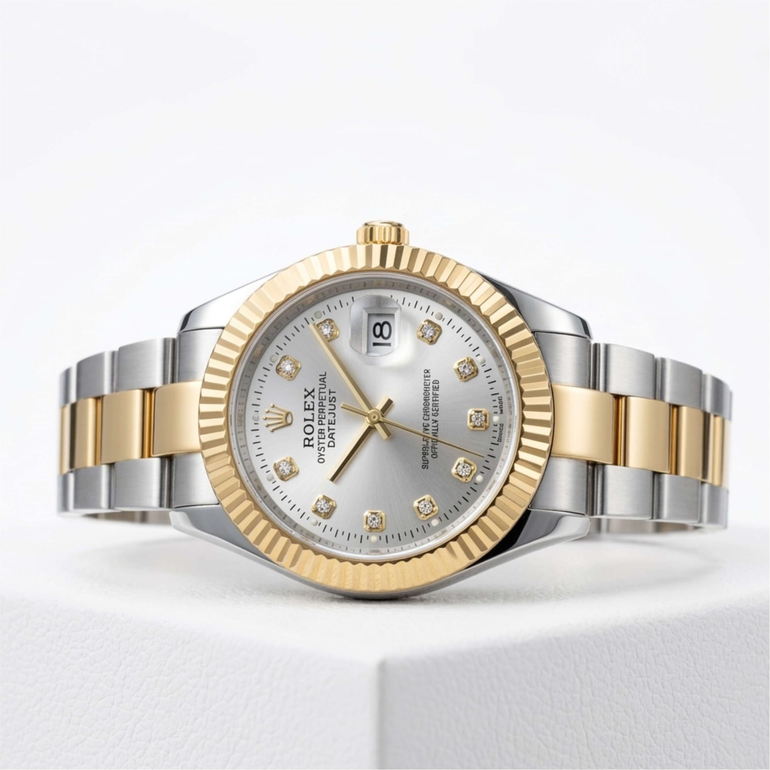 Two-tone silver and gold watch with diamond-studded face on a white background