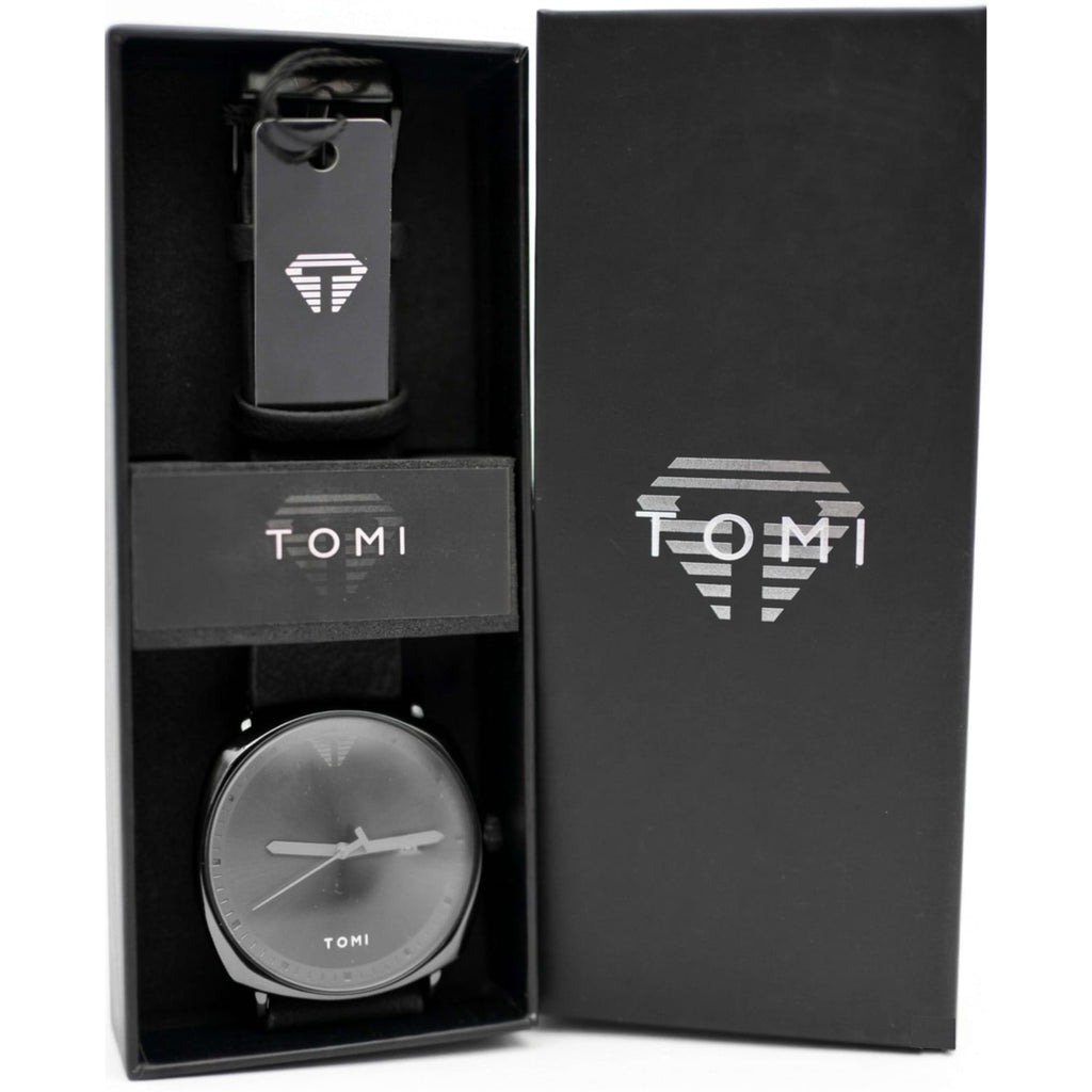 Black watch and keychain set with 'TOMI' branding in a black box.